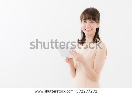 portrait of young asian businesswoman using tablet computer isolated on white background