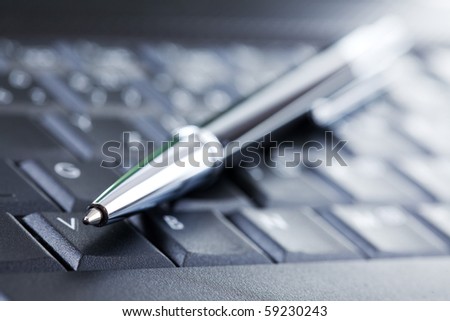 the luxury black pen on computer keyboard