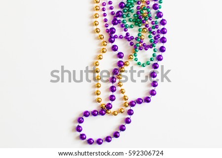 Mardi Gras beads on white background Royalty-Free Stock Photo #592306724