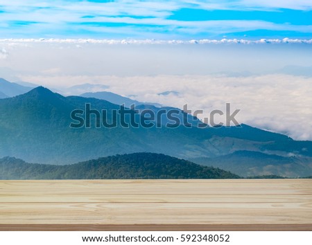 side view shot of wooden with blue sky, cloud and mountain background for slow life, relax, annual leave for worker office and still work