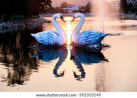 statue of Two swans, a heart-shaped with sunset and fountain at Kut Pong Public Park, Tambon Kut Pong, Amphoe Mueang Loei, Chang Wat Loei, Thailand