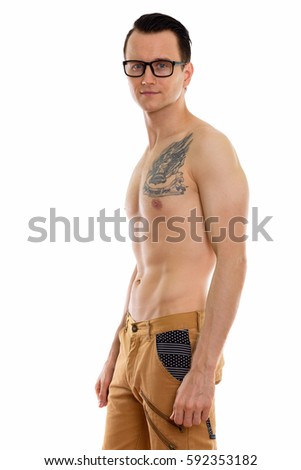 Studio shot of young handsome man standing shirtless while wearing eyeglasses with tattoo on neck meaning passion