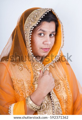 Beautiful Indian girl in traditional Indian clothing, isolated on white