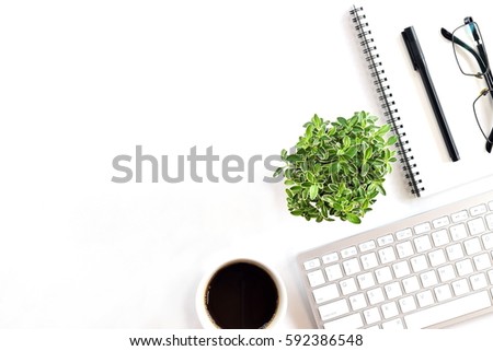 White minimal office desk table with computer, keyboard and cup of coffee. Top view with copy space, flat lay.