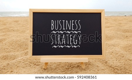 Text BUSINESS STRATEGY written on chalk board

