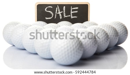 Used golf balls with 'SALE' text on mini blackboard