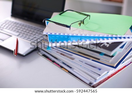 Group of multicolored office folders and glasses.