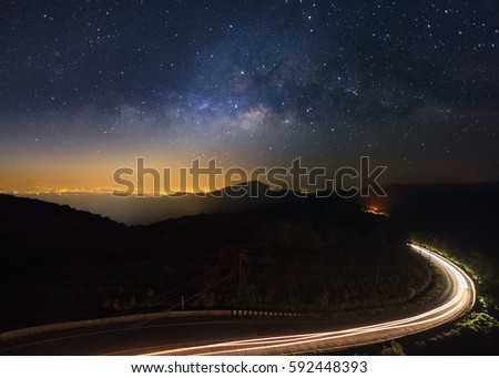 Milky Way Galaxy with lighting on the road at Doi inthanon Chiang mai, Thailand.Long exposure photograph.With grain