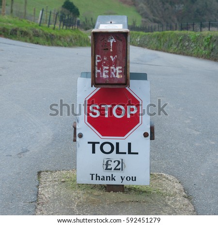 Stop Sign on a Toll Road with an Honesty Payment Box in the Valley of Rock near the Seaside Town of Lynton on the North Coast of Rural Devon, England, UK