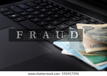 Fraud concept with money,card and computer in the background.