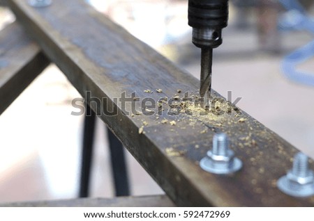 metal drill bit make holes in wooden board with expressive texture