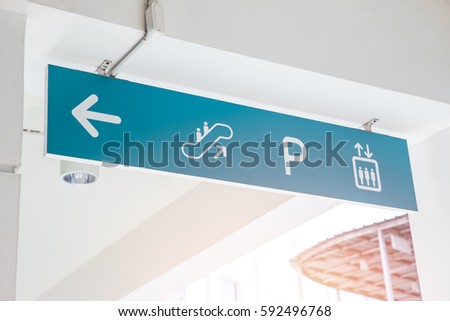 Building direction sing banner label arrow way to escalator car parking and lift elevator.