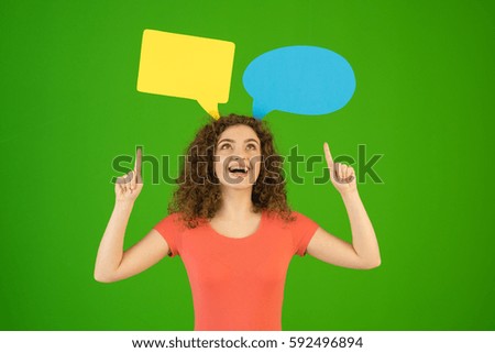 The woman gesture near a dialog signs on the green background