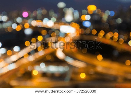 Night blurred light highway road intersection and city downtown abstract background
