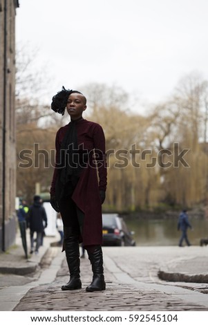 Woman in Boots in Street Style by a River