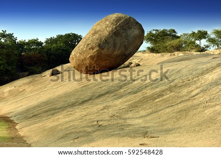 Krishna's butterball, the giant natural balancing rock in Mahabalipuram, Tamil Nadu, India Royalty-Free Stock Photo #592548428