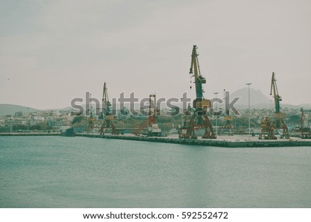 Boats and cranes  in the sea port. on the background containers