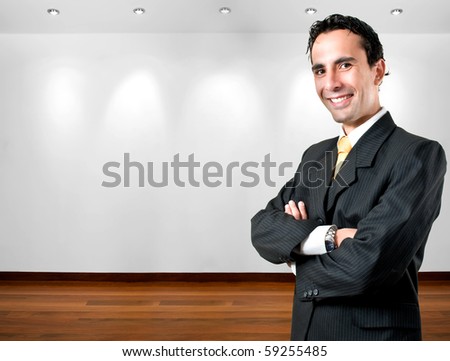 Elegant, young and smiling business man at office