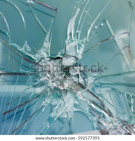 Firearms bullethole on the glass from the bullets, cracks background