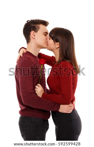 Teenage couple kissing, isolated on white background