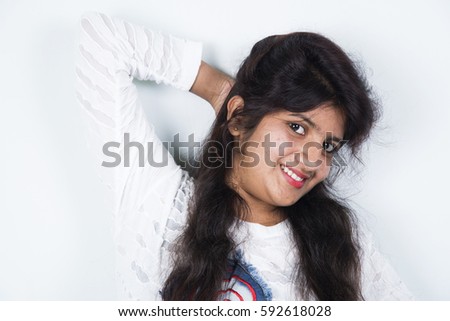 Beautiful, Young Cheerful Indian girl posing isolated over white background.