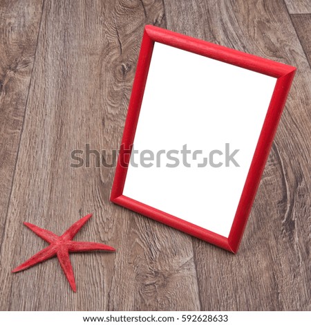 Picture frame and starfish on a wooden background