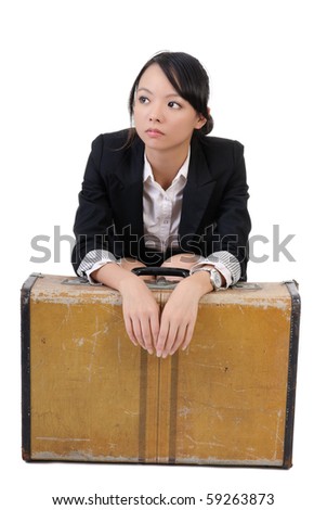 Lonely business girl sit with old traveling case, isolated on white background.