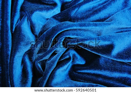 Dark Blue Velvet dress material cloth texture pattern. 
tailoring stitching concept. Shiny beautiful fashion fabric. Shiny clothing material sample.Creased fabric.