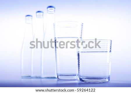 Cold, fresh water in bottles in blue background