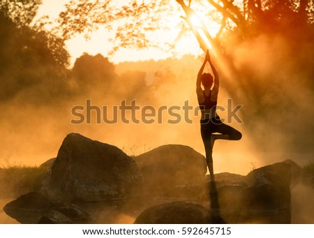 Young Asian woman practicing yoga pose in the park  yoga and meditation have good benefits for health. Photo concept for Yoga Sport and Healthy lifestyle Royalty-Free Stock Photo #592645715