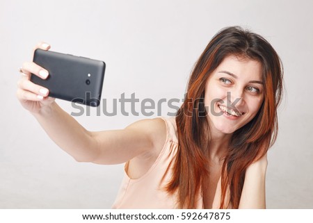 Young brunette woman taking self-ie
