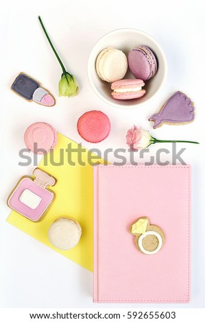 Colorful feminini flat lay of rose, pink note and cookies in the fashion style. Top view. 