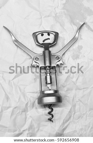 Corkscrew and drawing a sad face. Concept humor photo