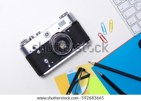 Top view of office graphic design pen mouse with laptop wireless mouse and vintage old camera on white table. Concept graphic design workplace