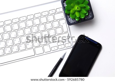 open daily, a computer and a smartphone on the desktop in the office