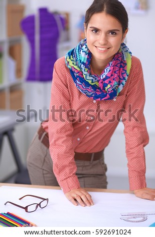 Modern young fashion designer working at studio.