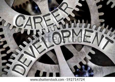 Macro photo of tooth wheel mechanism with CAREER DEVELOPMENT concept letters