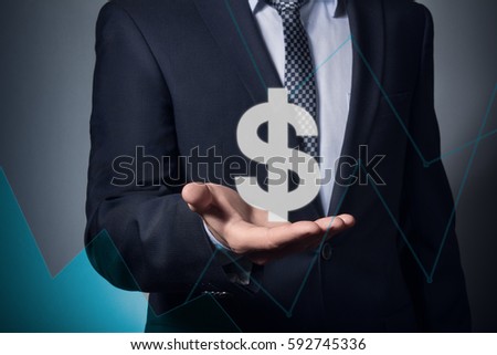 businessman holding currency symbol in hands. hand holds a dollar symbol.