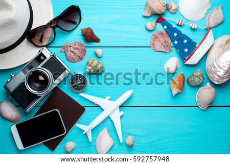Summer holiday background, travel concept with camera on wooden table background, top view