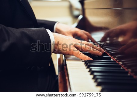 Playing classic piano. Professional musician pianist hands on piano keys.
