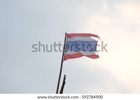 The flag of Thailand with three color, red, blue and white is on the sky