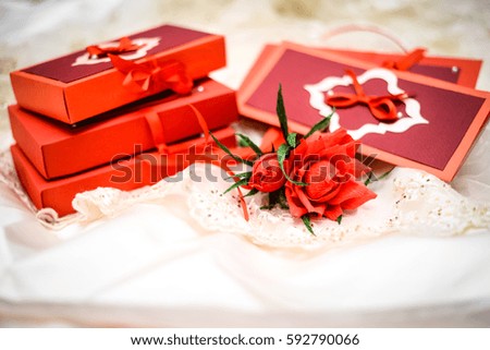 bunch of small red roses with crepe paper, gift box, invitation or greeting card 