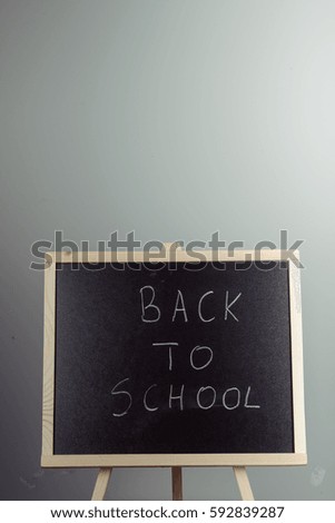 Back to school blackboard, chalkboard. Teacher writing back to school on black chalk board