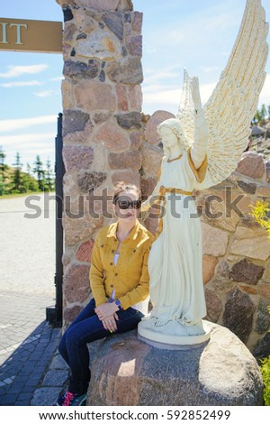 Marble statue of a beautiful angel in summer