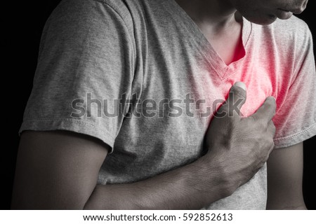 Man having chest pain, heart attack. Royalty-Free Stock Photo #592852613