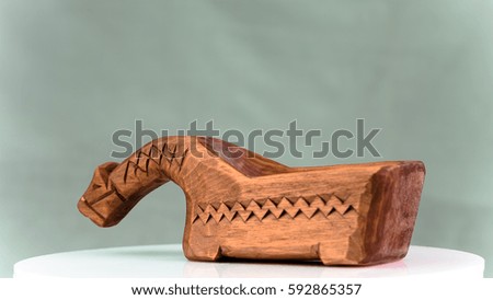 Horse toy handmade of wood in Russian style. Object photo.
