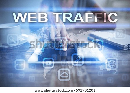 Woman using tablet pc, pressing on virtual screen and selecting web traffic.