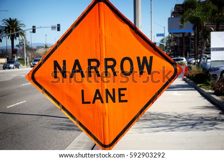  narrow lane sign on warning of road work ahead                             
