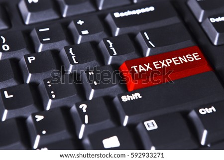 Picture of red button on the computer keyboard with text of tax expense