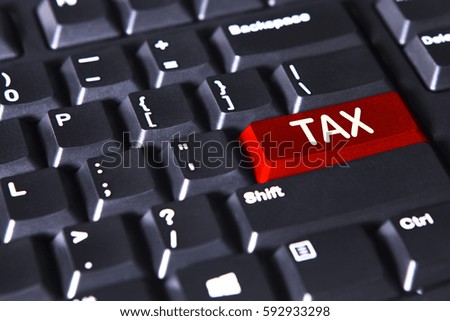 Picture of computer keyboard with tax word on the red button 
